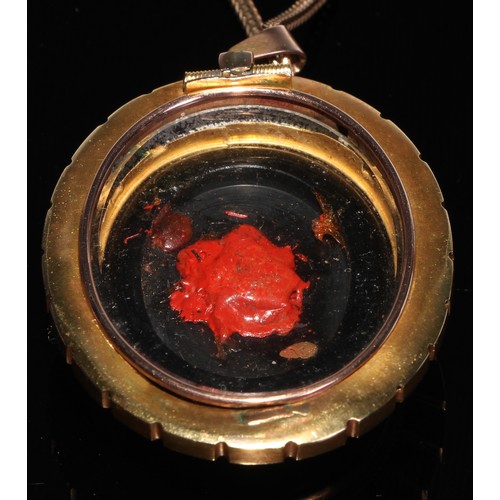 264 - Mourning jewellery - A large Victorian oval locket, decorated in black enamel and centered with inte... 