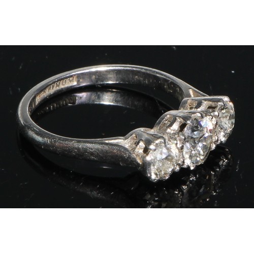 218 - A three stone diamond ring, brilliant cut stones, platinum shank, size K/L