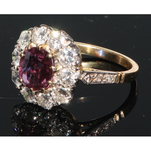 206 - A ruby and diamond cluster, the central facet cut ruby within 11 brilliant cut stones, 18ct yellow g... 