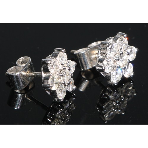 203 - A pair of seven stone diamond flowerhead cluster stud earrings, set in white metal