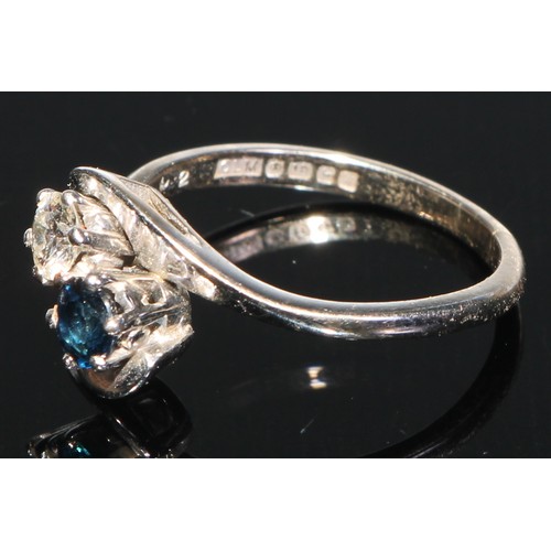 219 - A two stone diamond and sapphire cross over ring, 18ct white gold shank, size M/N