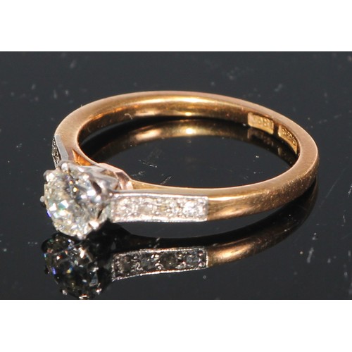 171 - A diamond solitaire ring, set eight further diamonds to shoulders, 18ct yellow gold, size M/N