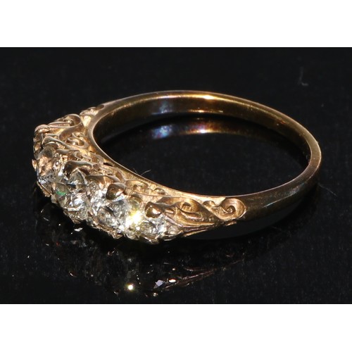 174 - A five stone diamond ring, the graduated stones within a scroll mount, 18ct yellow gold shank, size ... 