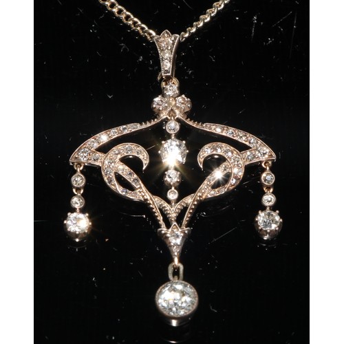 253 - An Art Nouveau style diamond open heart pendant necklace, with four principle old round cut diamond ... 