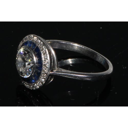 165 - A diamond and sapphire ring, central round brilliant cut diamond approx 1.15ct, surrounded by two co... 