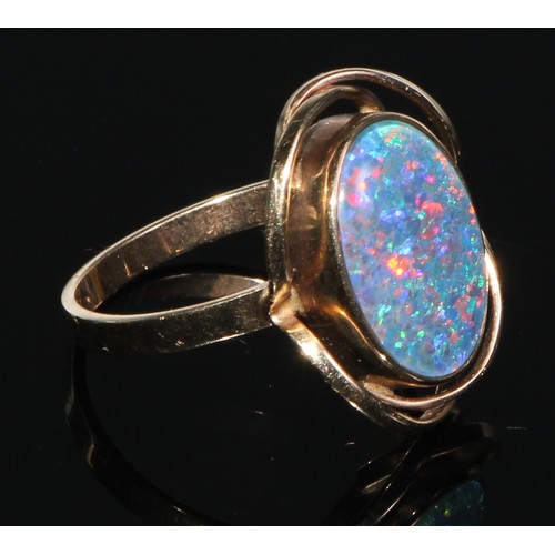 141 - A 9ct gold black opal oval cabochon ring, collar set within open shank, stamped 375, size P, 3.6g gr... 