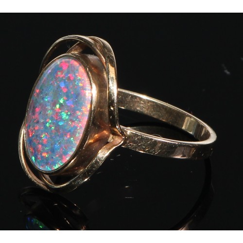 141 - A 9ct gold black opal oval cabochon ring, collar set within open shank, stamped 375, size P, 3.6g gr... 