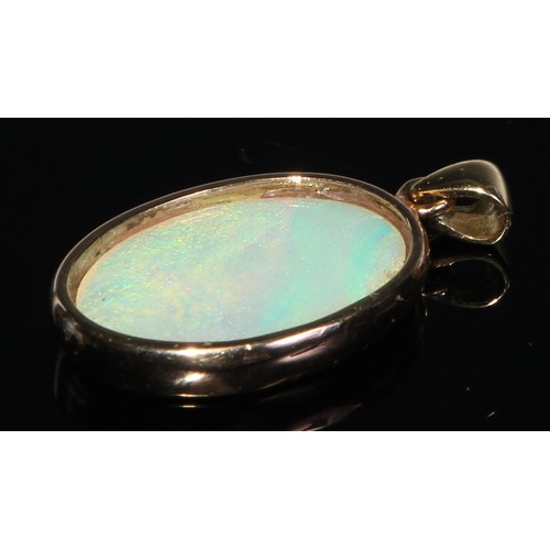 141 - A 9ct gold black opal oval cabochon ring, collar set within open shank, stamped 375, size P, 3.6g gr... 