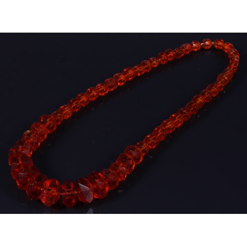 181 - A graduated deep orangy amber coloured resin faceted block bead necklace, beads ranging between appr... 