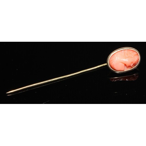 121 - A 19th century diamond and coral stick pin, central coral cabochon quartered by round old cut diamon... 