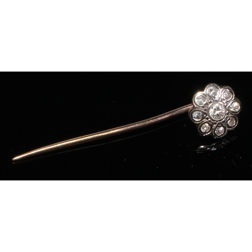 124 - A 19th century diamond floral cluster stick pin, set with nine old cut diamond accents, unmarked yel... 