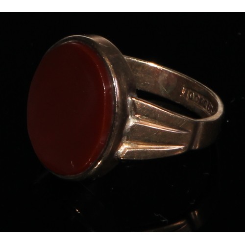 142 - A 9ct gold carnelian signet ring, plain oval matrix, stamped 9ct gold, 4.5g gross;  another garnet s... 