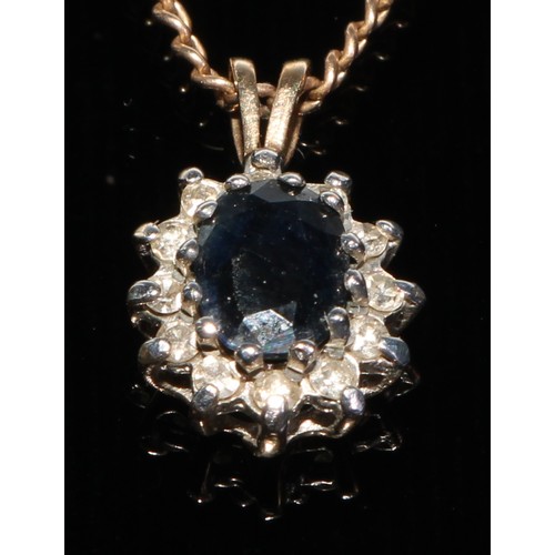 164 - A diamond and sapphire pendant necklace, cenral oval deep blue sapphire, approx 0.75ct, within twelv... 