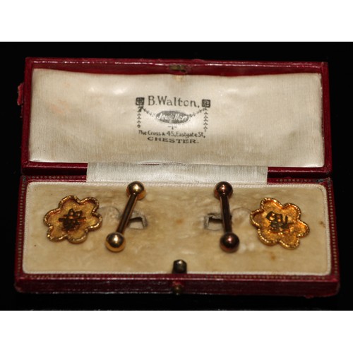 204 - A pair of yellow metal cufflinks, cast with oriental character and bar terminals, one indistinctly m... 