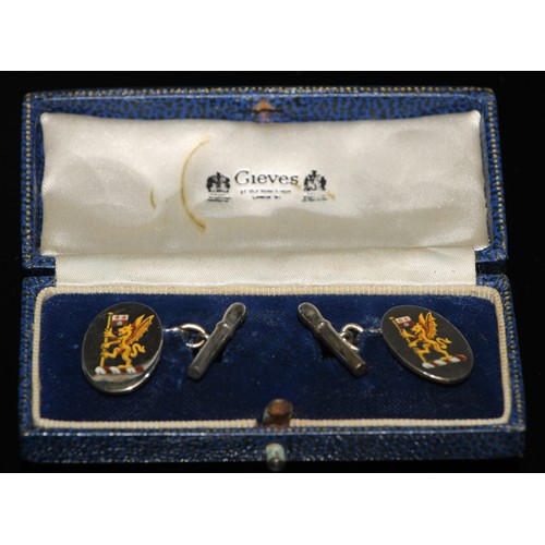 204 - A pair of yellow metal cufflinks, cast with oriental character and bar terminals, one indistinctly m... 