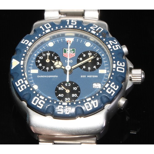 98 - Tag Heuer - a 1/10 chronograph quartz wristwatch,  blue dial,  luminous dot and block batons, three ... 