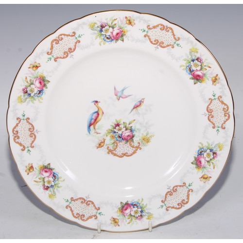 746 - A Royal Crown  Derby shaped circular plate, the field with three roses, within a shaped reserve, rub... 