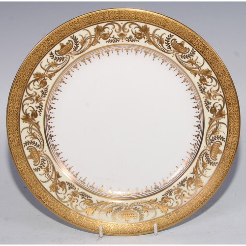 746 - A Royal Crown  Derby shaped circular plate, the field with three roses, within a shaped reserve, rub... 