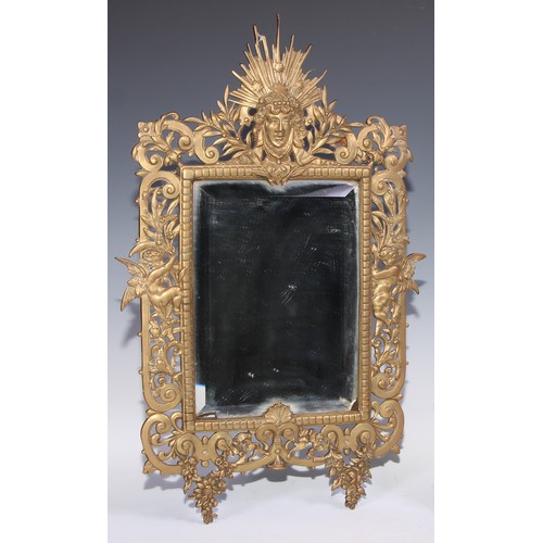 360 - A William Tonks and Sons brass rectangular mirror, cast with radiating mask, cherubs and pierced wit... 