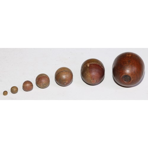 291 - A 19th century turned fruitwood miniature apple shaped box and cover, containing a set of six furthe... 