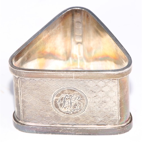 12 - A George V silver triangular napkin ring, engine turned, Birmingham 1920; eight other silver napkin ... 