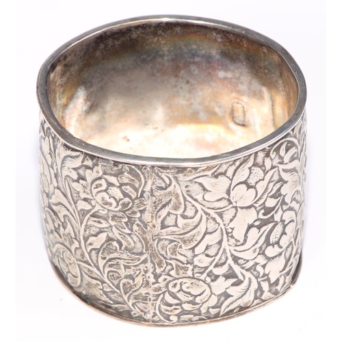 12 - A George V silver triangular napkin ring, engine turned, Birmingham 1920; eight other silver napkin ... 