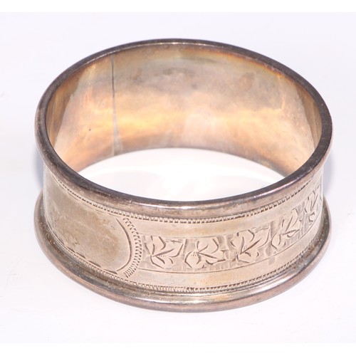 12 - A George V silver triangular napkin ring, engine turned, Birmingham 1920; eight other silver napkin ... 