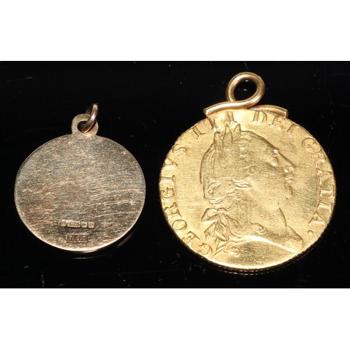 270 - A George III gold spade guinea, 1787, mounted, 8.6g gross; a 9ct gold St Christopher pendant, 2.9g (... 