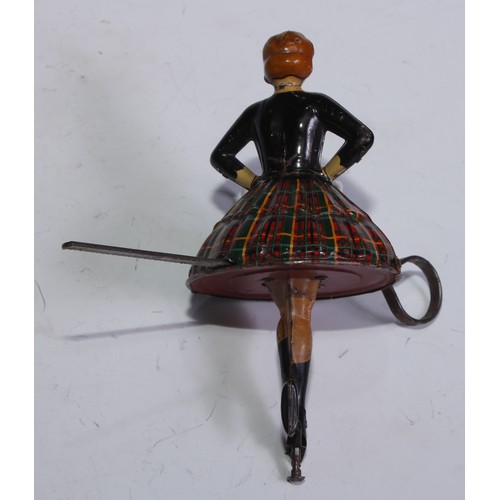 865 - Toys & Juvenalia - a 1930's novelty tinplate spinning top toy, in the form of a Scottish dancer, unm... 