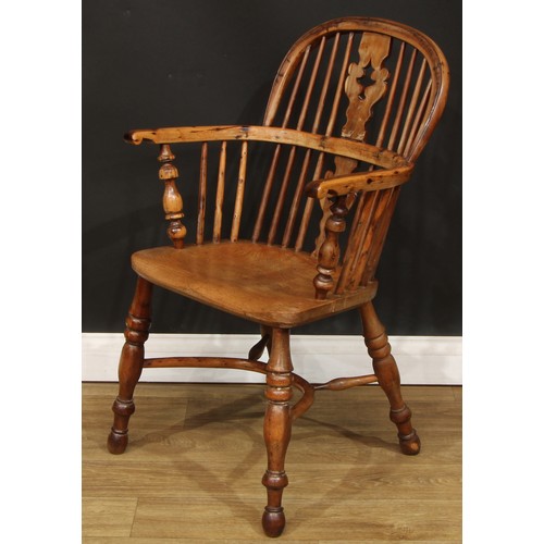 102 - A 19th century Yorkshire yew and elm Windsor elbow chair, hoop back, shaped and pierced Christmas tr... 