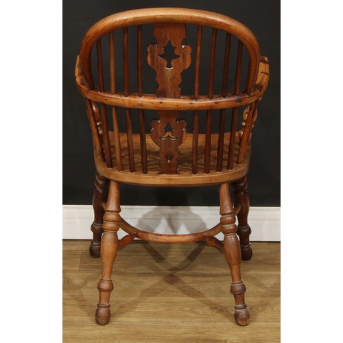 102 - A 19th century Yorkshire yew and elm Windsor elbow chair, hoop back, shaped and pierced Christmas tr... 