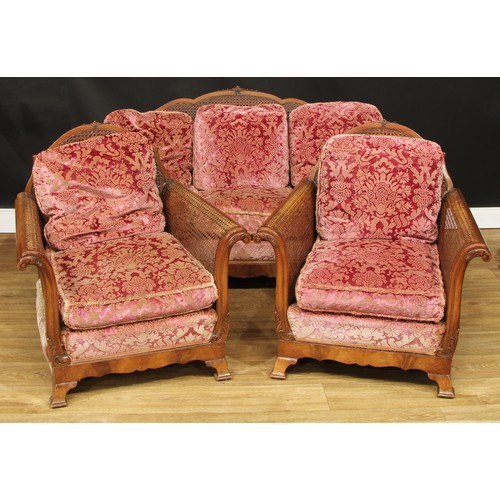 106 - A three-piece bergère drawing room suite, composing sofa and a pair of chairs, the sofa 82cm high, 1... 