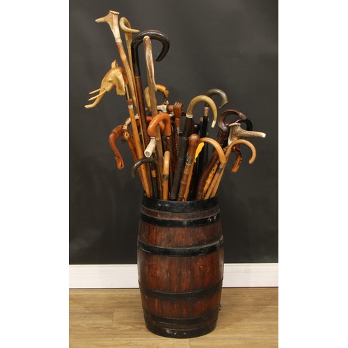 304 - A 19th century coopered oak barrel stick stand containing a collection of 19th century and later hor... 