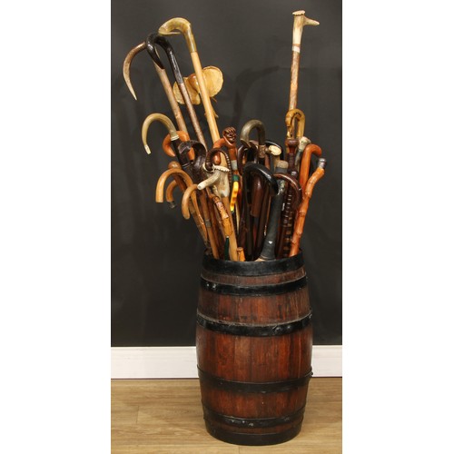 304 - A 19th century coopered oak barrel stick stand containing a collection of 19th century and later hor... 