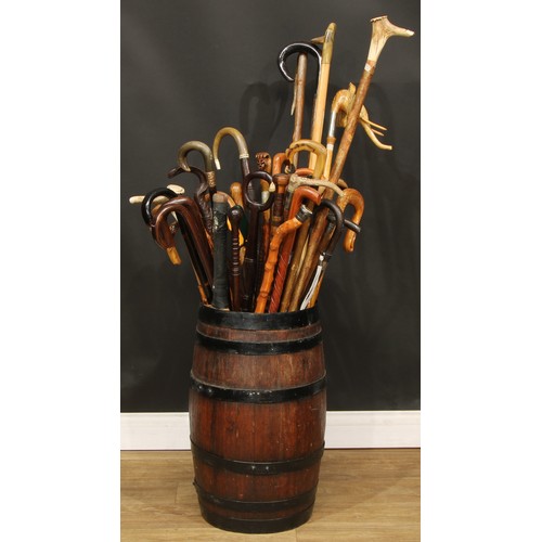 304 - A 19th century coopered oak barrel stick stand containing a collection of 19th century and later hor... 