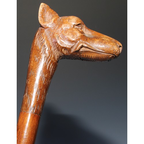 305 - A novelty walking stick, the softwood handle carved as a dogs head and neck, 91cm long; another, the... 