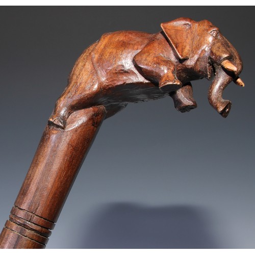 305 - A novelty walking stick, the softwood handle carved as a dogs head and neck, 91cm long; another, the... 