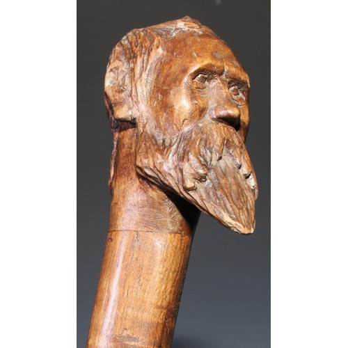 305 - A novelty walking stick, the softwood handle carved as a dogs head and neck, 91cm long; another, the... 