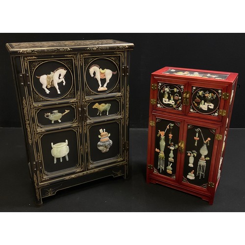 62 - An oriental black lacquer-type side cabinet, gilt and painted decoration, the pair of panelled doors... 