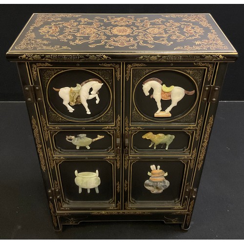 62 - An oriental black lacquer-type side cabinet, gilt and painted decoration, the pair of panelled doors... 