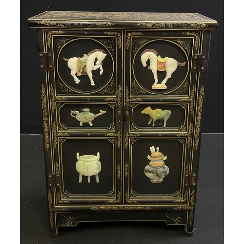 62 - An oriental black lacquer-type side cabinet, gilt and painted decoration, the pair of panelled doors... 