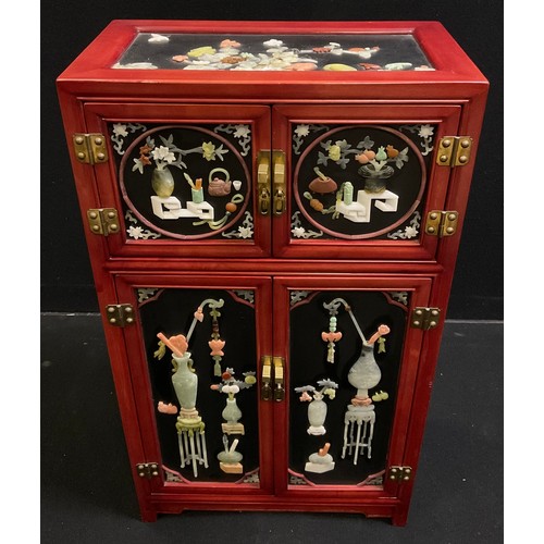 62 - An oriental black lacquer-type side cabinet, gilt and painted decoration, the pair of panelled doors... 