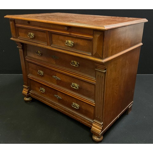 90 - A late 19th century French walnut chest of drawers with brushing slide to over-sailing top, above a ... 