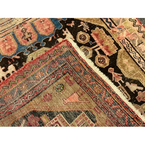 95 - An antique Qashqai type Persian runner carpet / rug, hand-knotted with stylised people, birds, and a... 