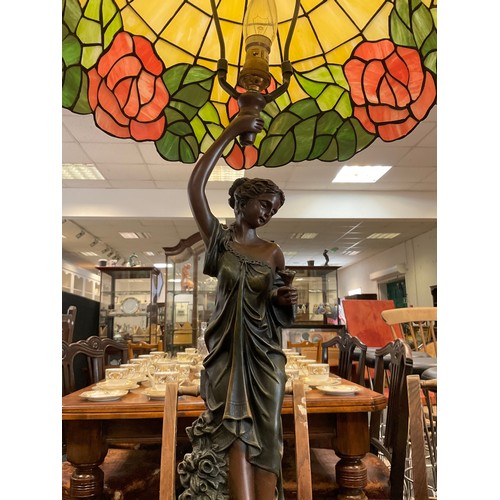 98 - A Tiffany style leaded glass table lamp, the faux bronze base as a young lady collecting roses, 69cm... 