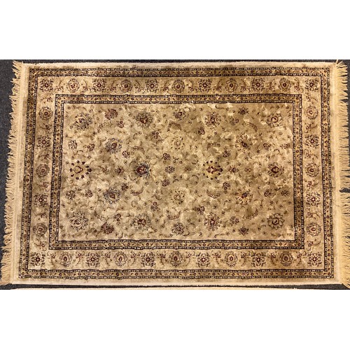 337 - An eastern silk and wool mix rug / carpet, the central field woven with stylised flowers, enclosed w... 