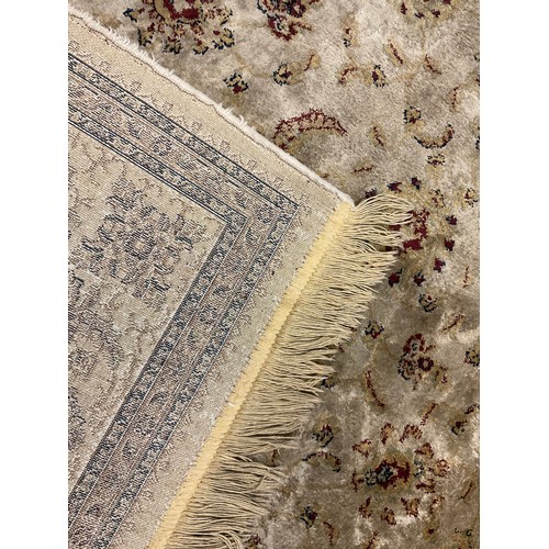 337 - An eastern silk and wool mix rug / carpet, the central field woven with stylised flowers, enclosed w... 