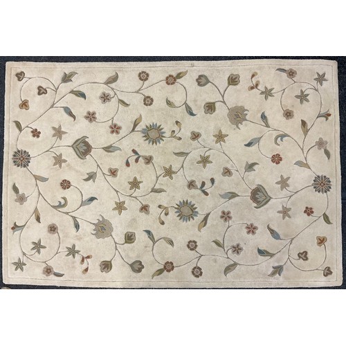 337 - An eastern silk and wool mix rug / carpet, the central field woven with stylised flowers, enclosed w... 