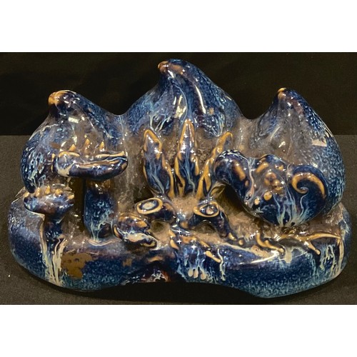 67 - A Chinese blue drip glazed brush rest, modelled as peaches, 16cm wide