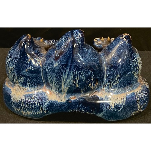 67 - A Chinese blue drip glazed brush rest, modelled as peaches, 16cm wide